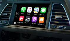 an apple carp in the center of a car with various app icons on it's screen