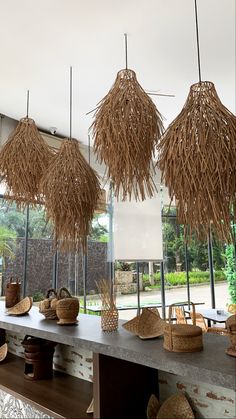 straw baskets hanging from the ceiling in a store