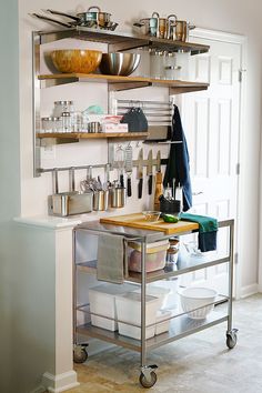 a kitchen with stainless steel shelving and shelves