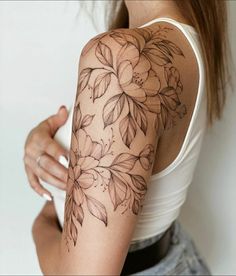 a woman with a flower tattoo on her arm