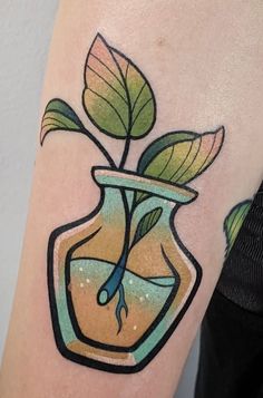 a small vase with a plant in it on the left side of the arm is painted yellow and green