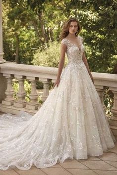 a woman in a wedding dress standing on a balcony