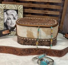 an old fashion purse and other items sit on a table next to a photo frame