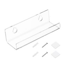 a clear plastic shelf with four screws and two pieces of white paper next to it