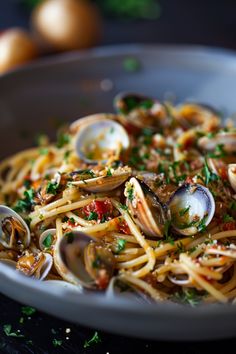 pasta with clams and parsley in a bowl