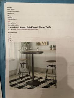 a table and two stools sitting in front of a window with the words chambord round solid wood dining table