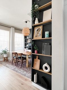 an open bookcase in the corner of a dining room