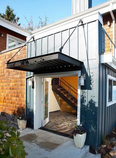 an instagramted photo of a small house with a patio attached to the front door