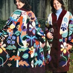 two women standing next to each other wearing colorful knitted sweaters and jackets with flowers on them