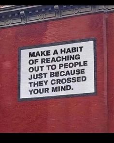 a sign on the side of a building that says make a habit of reaching out to people just because they crossed your mind