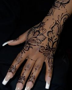 a woman's hand with black and white designs on it