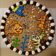 there is a decorated cake in the shape of a fish and other animals on it