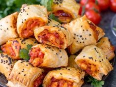 several pieces of pizza wrapped in bread and garnished with parsley on a plate