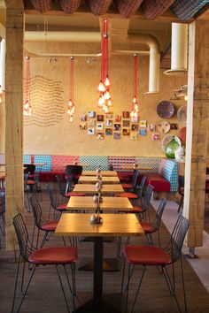 a restaurant with wooden tables and colorful chairs