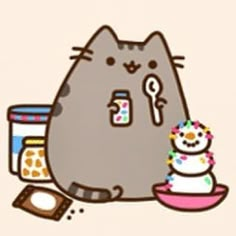 a cat with a cupcake in front of it and a cookie on the other side