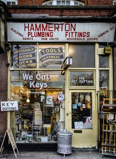 a store front with signs and tools in the window