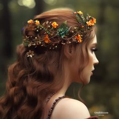 a woman with long red hair wearing a crown of flowers and leaves on her head