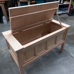 a wooden bench sitting in the middle of a shop floor next to other workbench