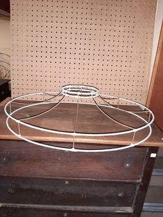 an old wooden dresser with a metal rack on top