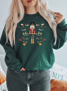 Celebrate the holiday season in style with this Nutcracker Christmas Sweatshirt for Women! This cozy and festive Christmas crewneck is perfect for staying warm and stylish during the winter months. Featuring a charming Nutcracker design, this holiday sweatshirt is great for Christmas parties, family gatherings, or casual wear throughout the holiday season. Made from soft, high-quality fabric, it's designed for comfort and durability, making it a must-have addition to your winter wardrobe. This f Christmas Crewneck, Cute Graphic Tees, Cozy Holiday, Xmas Shirts, Sweatshirt For Women, Holiday Sweatshirt, Women Christmas, Winter Sweater, Sweatshirt Christmas