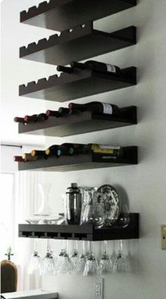 there is a wine rack in the corner of this room with many glasses on it