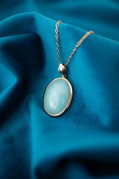 Vintage 9ct Yellow Gold Teal Chalcedony Enhancer Pendant. Metal: 9ct Yellow Gold   Stone: Chalcedony   Size: 20.5mm x 30mm     Price: $725.00     007-00036     Please view all photos as they form part of the description.   This item will be presented in one of our gorgeous boxes and carefully packaged should you wish to have it posted to you. Luxury Oval Jade Necklaces, Hallmarked Oval Jade Necklaces, Oval Jade Necklaces With Hallmark, Elegant Jade Necklace For Formal Occasions, Luxury Oval Cabochon Necklace, Oval Jade Cabochon Necklace, Oval Jade Cabochon Necklaces, Formal Fine Jewelry Jade Necklace, Luxury Jade Necklaces For Wedding