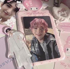 an image of a person with pink hair and other items on the table in front of them