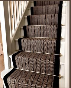 the carpet on the stairs is brown and black