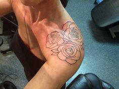 a woman with a rose tattoo on her arm