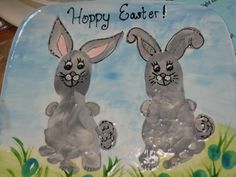 a plate with two rabbits on it and the words happy easter written in large letters