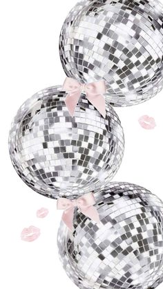 three silver disco balls with pink bows on them