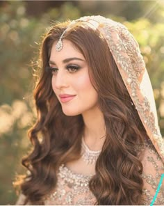 a woman with long hair wearing a veil