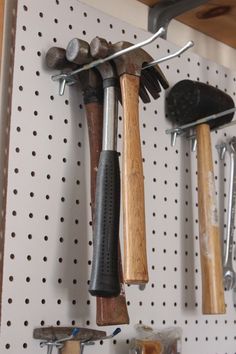 there are many tools hanging on the wall