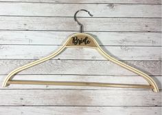 a wooden hanger with the word bye on it