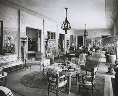 an old black and white photo of a formal dining room