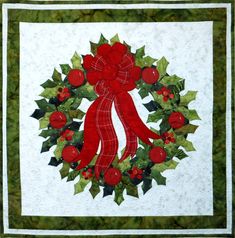 a holly wreath quilt design with appliqued holly leaves and berries. Wreath includes a large tartan ribbon at the top. The quilt is finished with two borders and binding. Wreath Quilt, Quilted Table Runners Christmas, Christmas Advent Wreath, Table Topper Patterns, Holly Wreath, Applique Quilt Patterns, Applique Quilting, Winter Quilts, Holiday Patterns