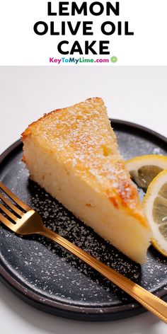 a slice of lemon olive oil cake on a black plate with a gold fork next to it