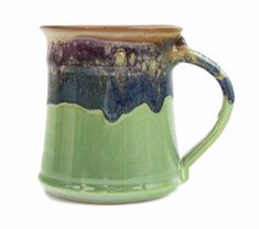 a green ceramic mug with blue and purple glaze