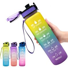 a hand holding a water bottle with three different colors