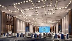 an empty banquet hall with tables and chairs set up for a formal function at night