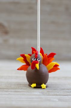 a chocolate turkey lollipop with a stick sticking out of it