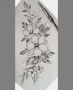 a pencil drawing of flowers and leaves on a piece of paper with a pen next to it