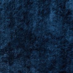 a dark blue area rug that looks like fur