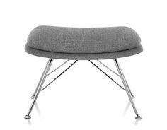 an upholstered chair with metal legs and a gray seat cushion on top of it