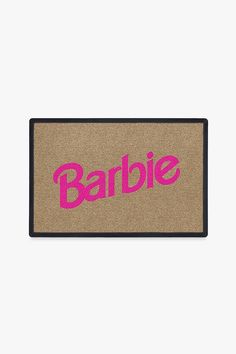 a door mat with the word barbie printed in pink on it, against a white background