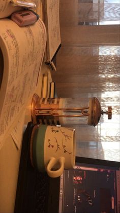 a coffee cup sitting on top of a counter next to a wall mounted musical instrument