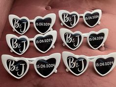 six heart shaped magnets with the names of each individual in black and white on them