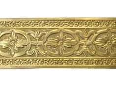 an ornately decorated gold metal object on a white background