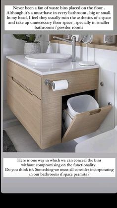 a bathroom with a sink, mirror and toilet paper dispenser in it