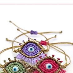 three bracelets with evil eyes on them